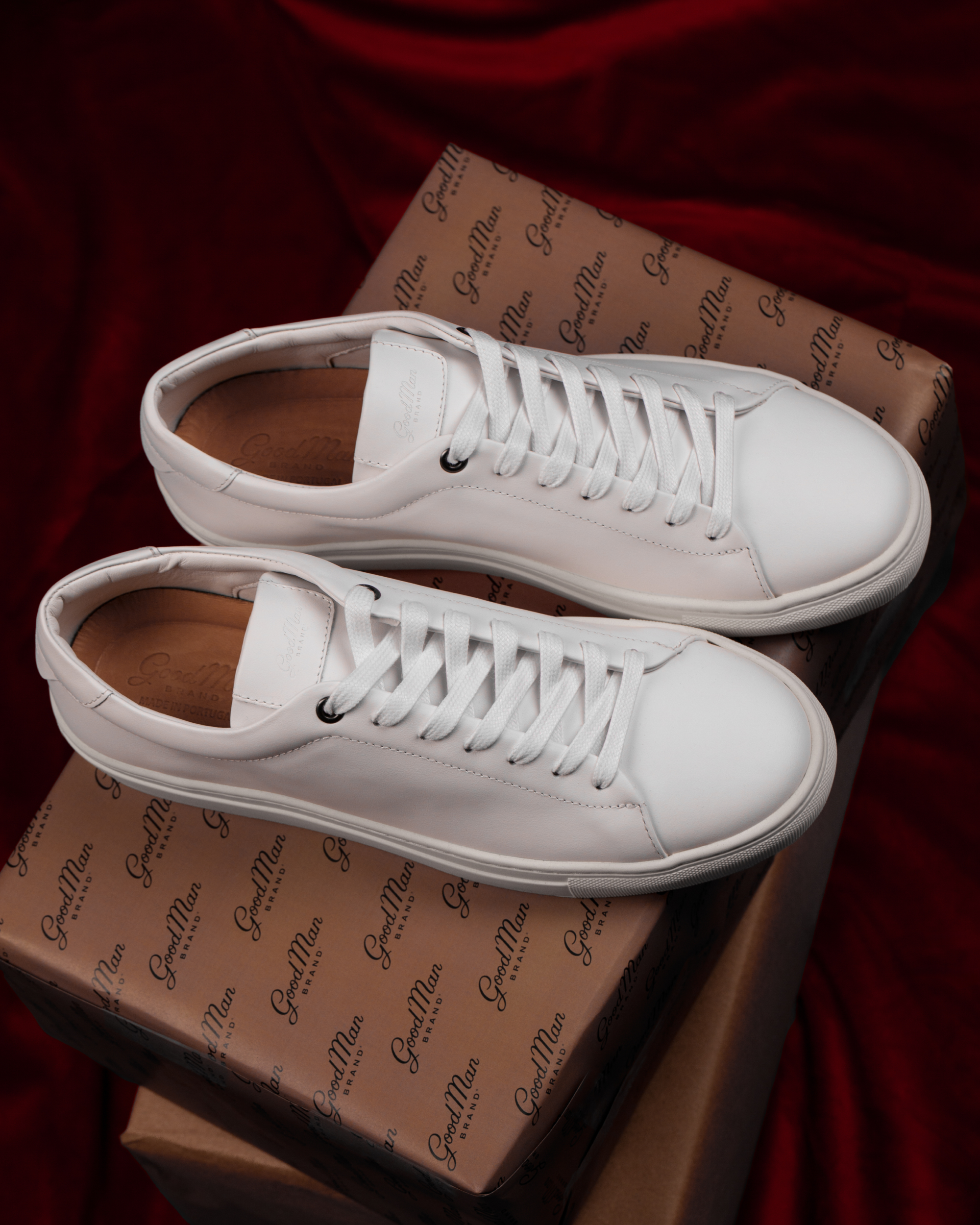 White sneakers on a box with 'Good Man Brand' packaging